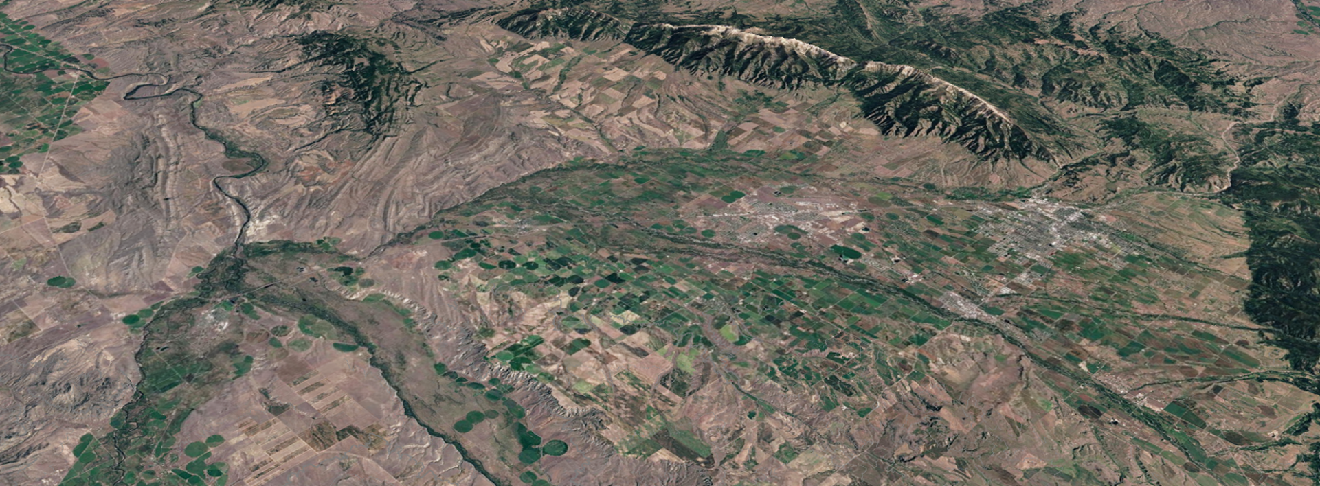 Overhead view of natural landscape with green areas and mountains