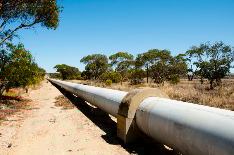 Pipeline On Field Against Clear Blue Sky-1