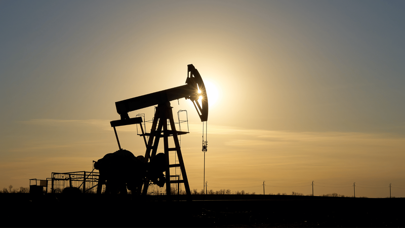 Image of oil drilling at sunset